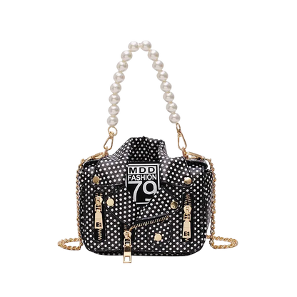 Black polka dot handbag with pearl handle and gold chain on a white background