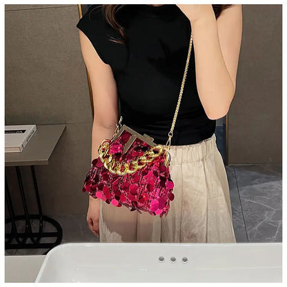 Person holding a pink and gold handbag in an indoor setting