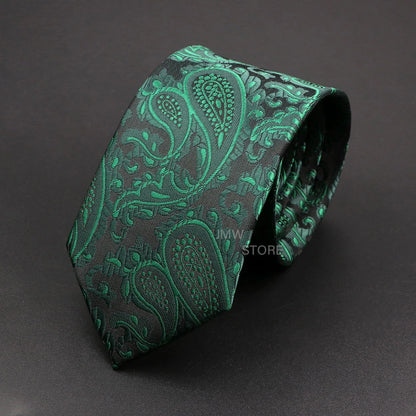 Green paisley patterned tie on a dark gray background