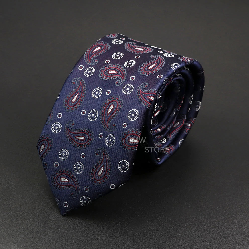 Navy blue tie with red and white paisley pattern on a dark gray background