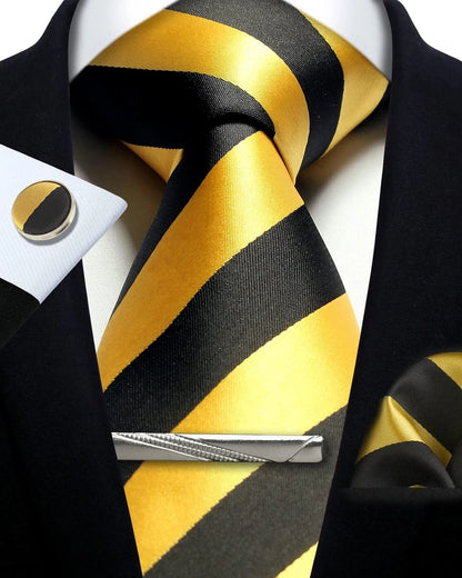 Black and yellow striped tie with a matching pocket square and cufflinks on a white shirt.