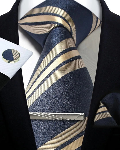 Navy and beige striped tie with matching pocket square and cufflinks on a black suit.
