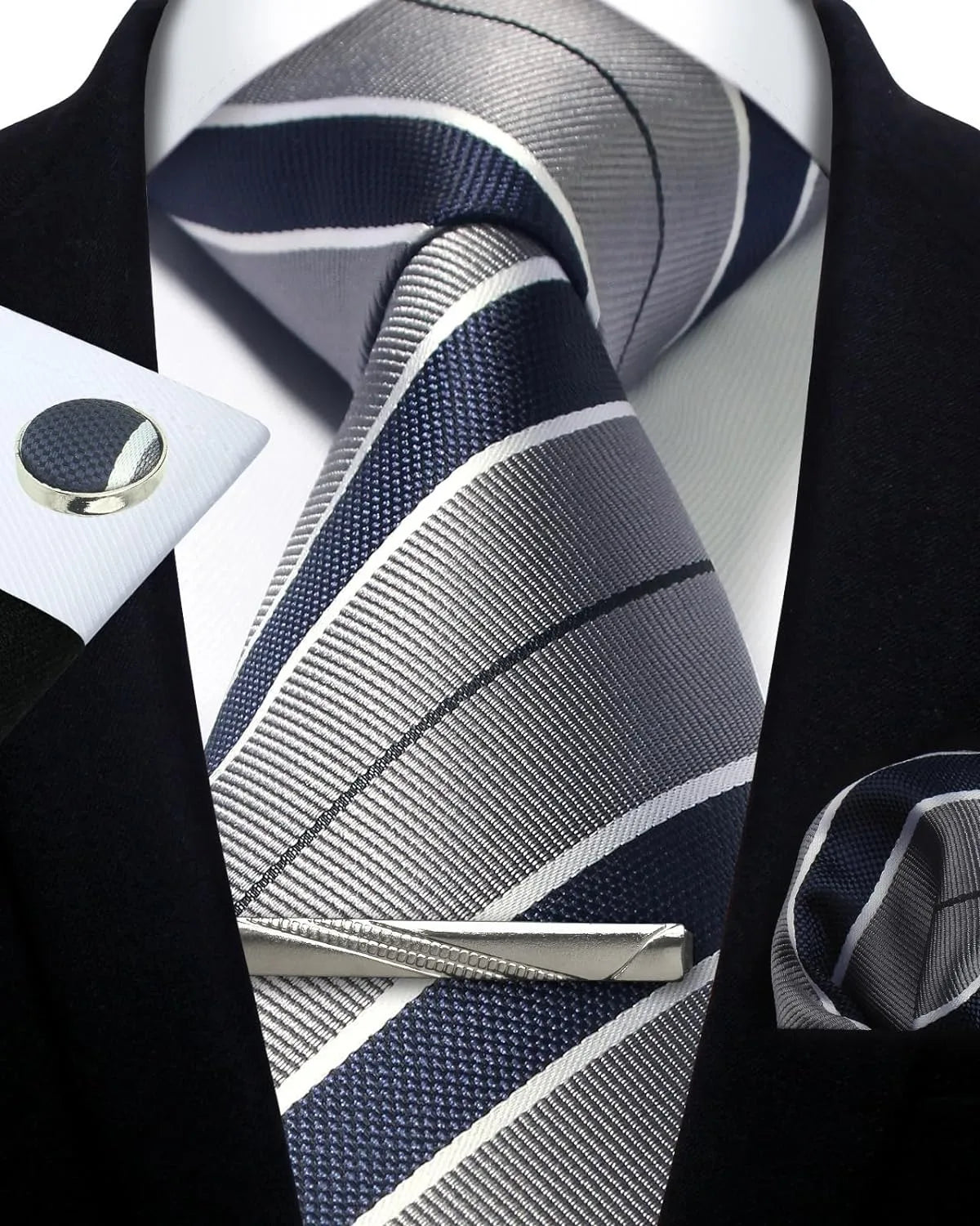 Navy and gray striped tie with matching pocket square and cufflinks on a black suit.